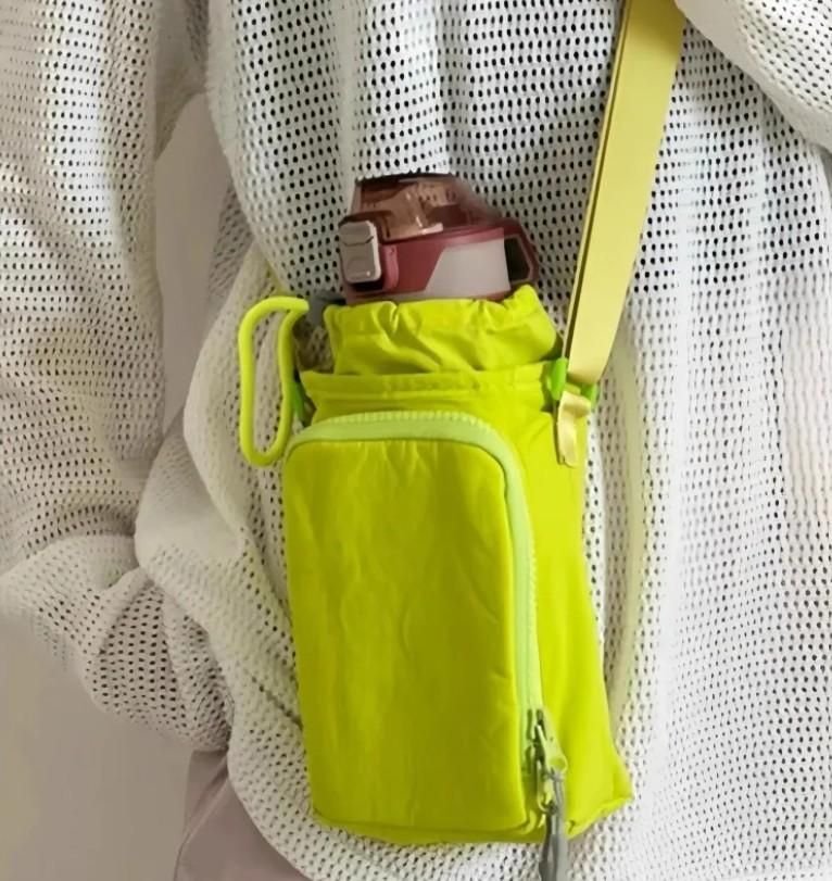 Neon yellow stylish side sling pouch with zipper pocket and water bottle holder worn over white mesh shirt