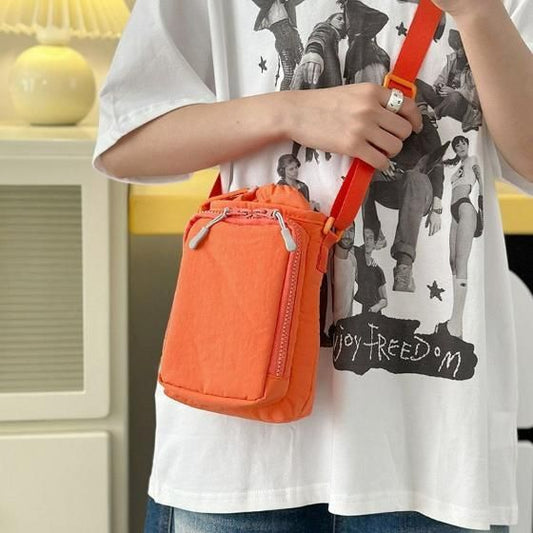 Orange stylish side sling pouch worn crossbody with adjustable strap for casual use